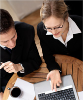 Two colleagues reviewing documents together